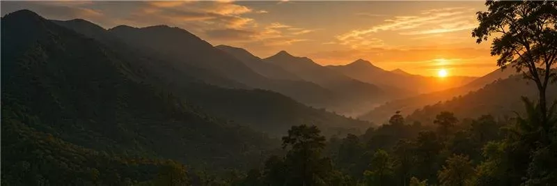 The Pothigai hills silhouetted against a golden sunset
